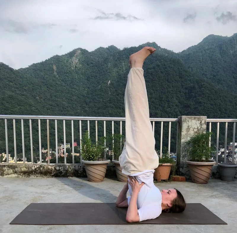 Yoga practitioner performing Sarvangasana Shoulder Stand Pose for balance and strength