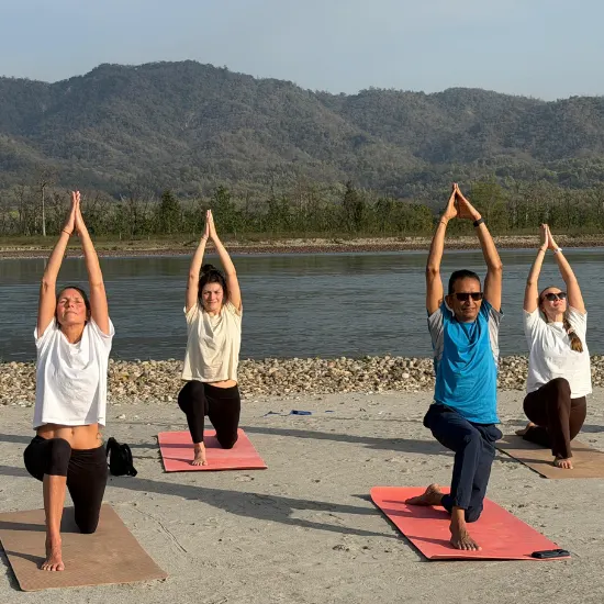 Yoga trainees practicing yoga on the beach at sunrise during a 200 Hour Yoga Teacher Training program in India.