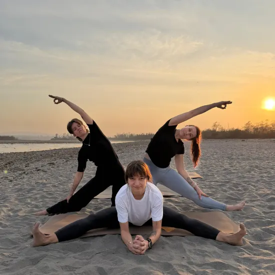 Yoga students practicing advanced asanas during a 300 Hour Yoga Teacher Training in India surrounded by peaceful natural scenery.