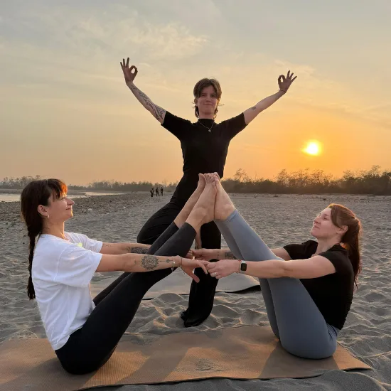Yoga trainee practicing yoga on the beach during sunrise, focusing on balance, mindfulness, and relaxation in a peaceful natural setting.