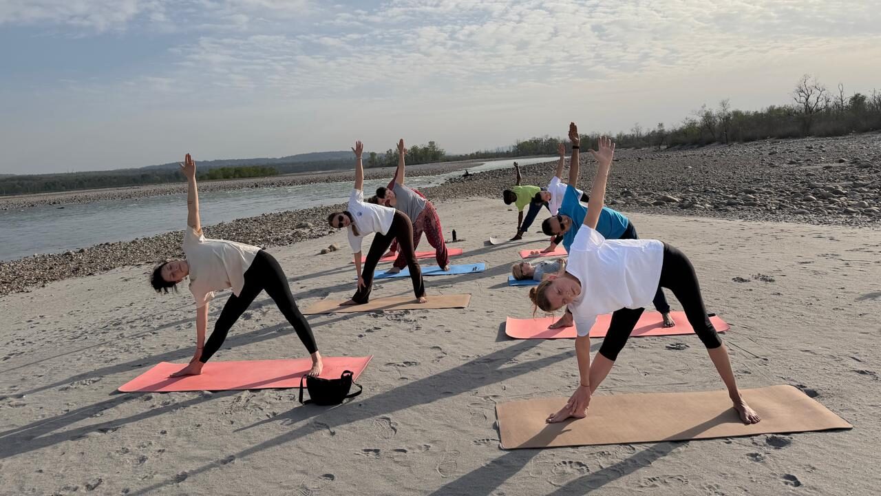 Students practicing asana during a yoga teacher training in Rishikesh